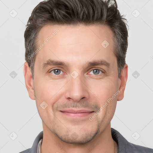 Joyful white adult male with short  brown hair and brown eyes