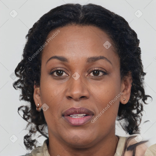 Joyful black adult female with long  brown hair and brown eyes