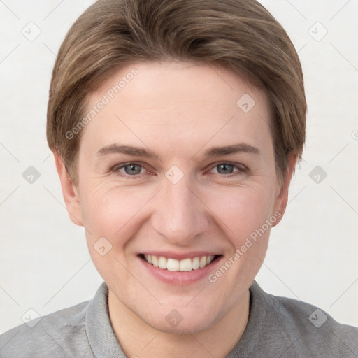 Joyful white young-adult female with short  brown hair and grey eyes