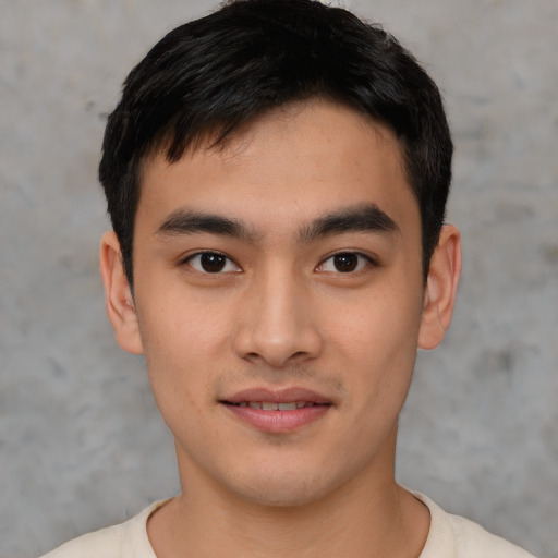 Joyful asian young-adult male with short  black hair and brown eyes