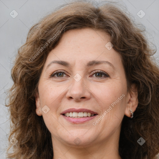 Joyful white adult female with long  brown hair and brown eyes