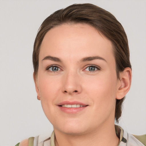 Joyful white young-adult female with short  brown hair and grey eyes