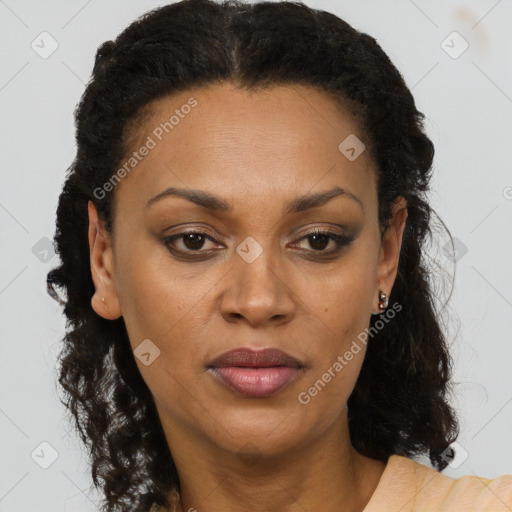 Joyful black adult female with long  brown hair and brown eyes