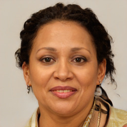 Joyful black adult female with medium  brown hair and brown eyes