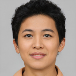 Joyful asian young-adult female with short  brown hair and brown eyes