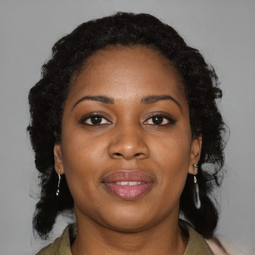 Joyful black young-adult female with medium  brown hair and brown eyes
