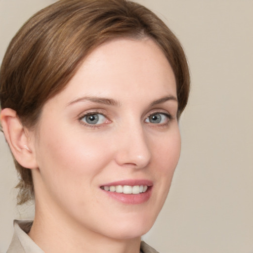 Joyful white young-adult female with medium  brown hair and grey eyes