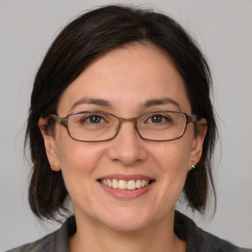 Joyful white adult female with medium  brown hair and brown eyes