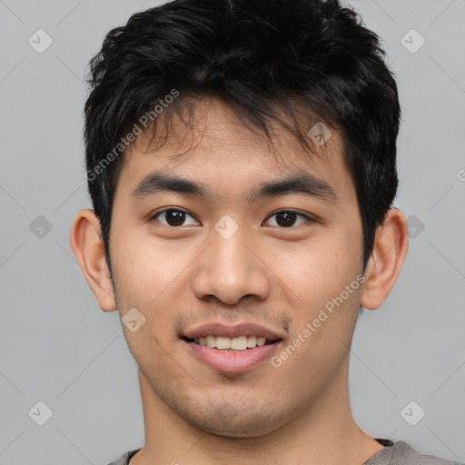 Joyful asian young-adult male with short  black hair and brown eyes