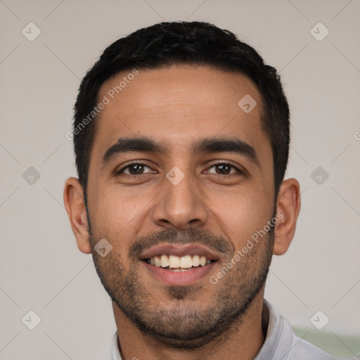 Joyful latino young-adult male with short  black hair and brown eyes