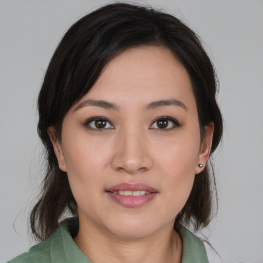 Joyful asian young-adult female with medium  brown hair and brown eyes