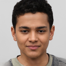 Joyful latino young-adult male with short  brown hair and brown eyes