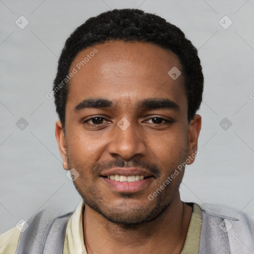 Joyful black young-adult male with short  black hair and brown eyes