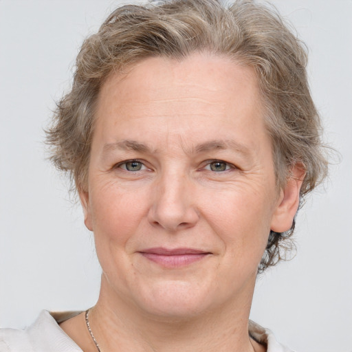 Joyful white adult female with short  brown hair and grey eyes