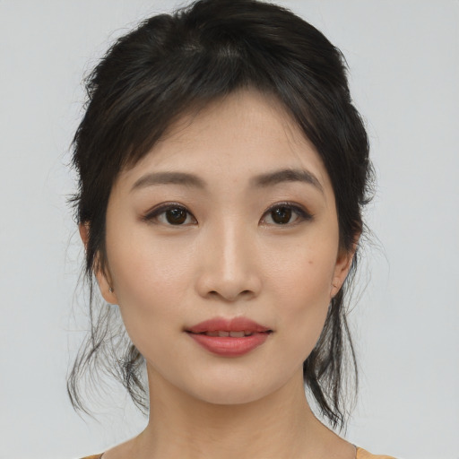 Joyful asian young-adult female with medium  black hair and brown eyes