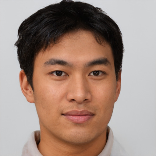 Joyful asian young-adult male with short  brown hair and brown eyes
