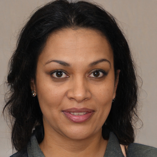 Joyful black young-adult female with medium  brown hair and brown eyes