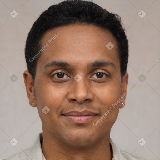 Joyful black young-adult male with short  black hair and brown eyes