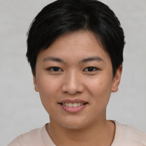 Joyful asian young-adult female with short  black hair and brown eyes