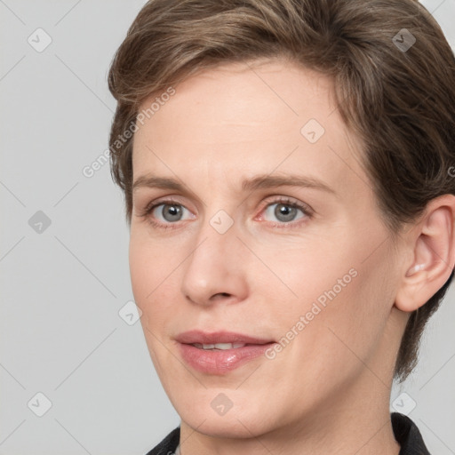 Joyful white young-adult female with short  brown hair and grey eyes