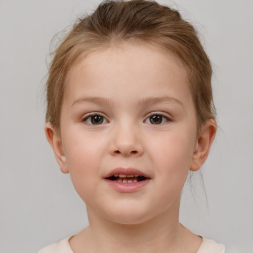 Joyful white child female with short  brown hair and brown eyes