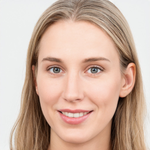 Joyful white young-adult female with long  brown hair and blue eyes