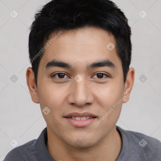 Joyful asian young-adult male with short  black hair and brown eyes