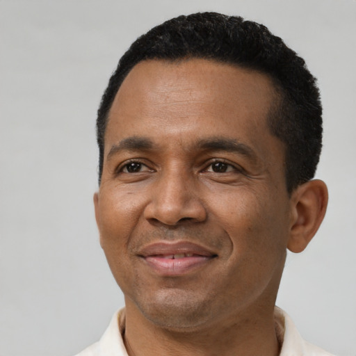 Joyful black adult male with short  black hair and brown eyes