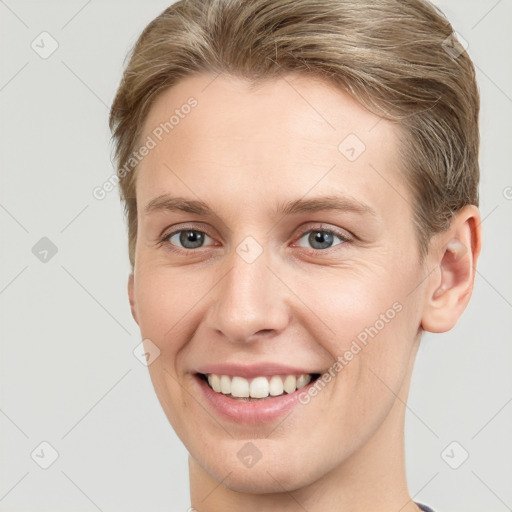 Joyful white young-adult female with short  brown hair and grey eyes