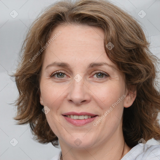 Joyful white adult female with medium  brown hair and blue eyes