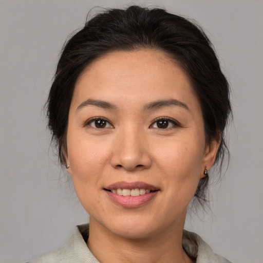 Joyful asian young-adult female with medium  brown hair and brown eyes
