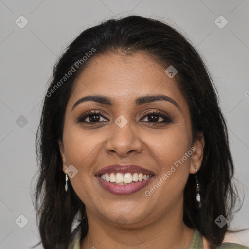 Joyful latino young-adult female with medium  brown hair and brown eyes