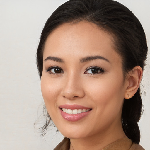 Joyful white young-adult female with long  brown hair and brown eyes