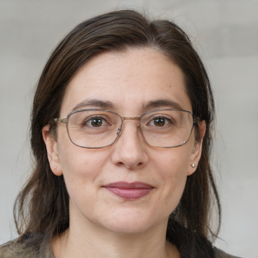 Joyful white adult female with medium  brown hair and brown eyes