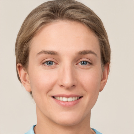 Joyful white young-adult female with short  brown hair and grey eyes