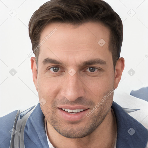 Joyful white young-adult male with short  brown hair and grey eyes