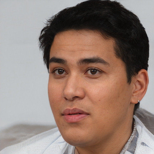 Joyful asian young-adult male with short  black hair and brown eyes