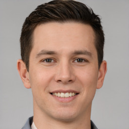 Joyful white young-adult male with short  brown hair and brown eyes