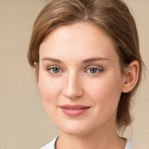 Joyful white young-adult female with medium  brown hair and blue eyes