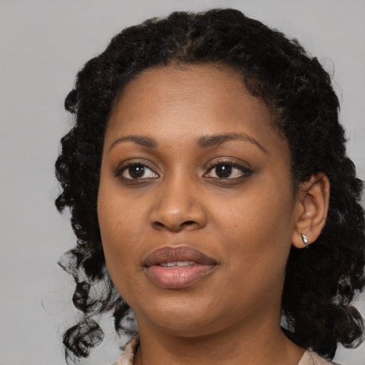 Joyful black young-adult female with medium  black hair and brown eyes