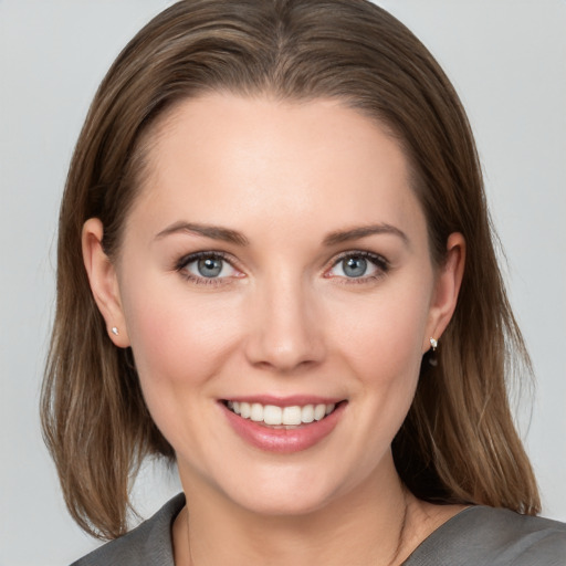 Joyful white young-adult female with medium  brown hair and grey eyes