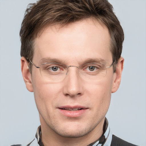 Joyful white adult male with short  brown hair and grey eyes