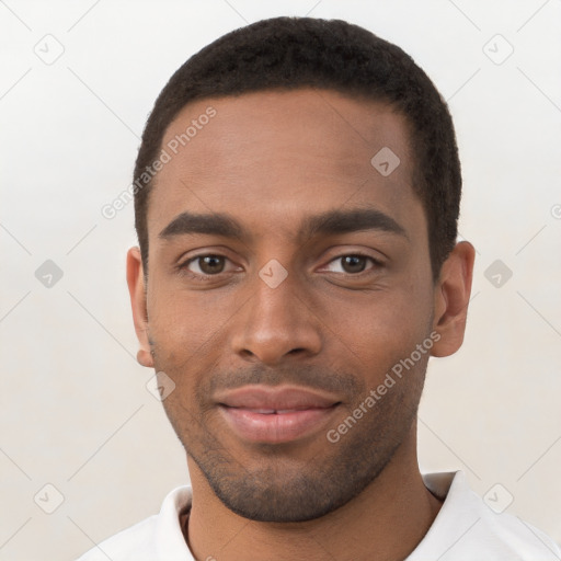 Joyful black young-adult male with short  brown hair and brown eyes