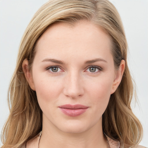 Joyful white young-adult female with long  brown hair and blue eyes