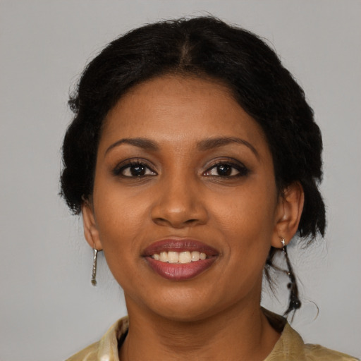 Joyful black young-adult female with medium  brown hair and brown eyes