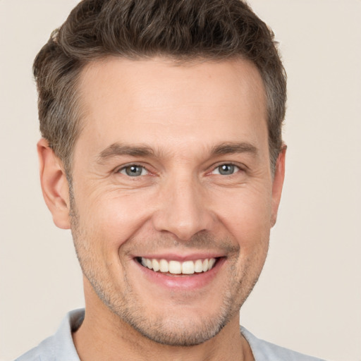 Joyful white adult male with short  brown hair and brown eyes