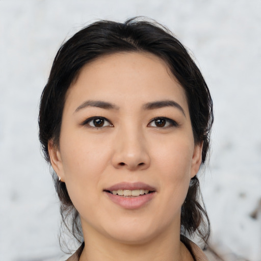 Joyful asian young-adult female with medium  black hair and brown eyes