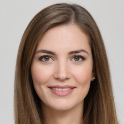 Joyful white young-adult female with long  brown hair and green eyes