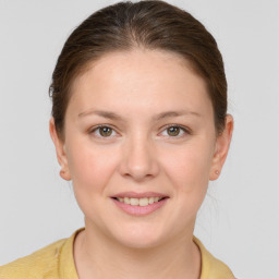 Joyful white young-adult female with short  brown hair and grey eyes