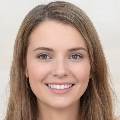 Joyful white young-adult female with long  brown hair and grey eyes